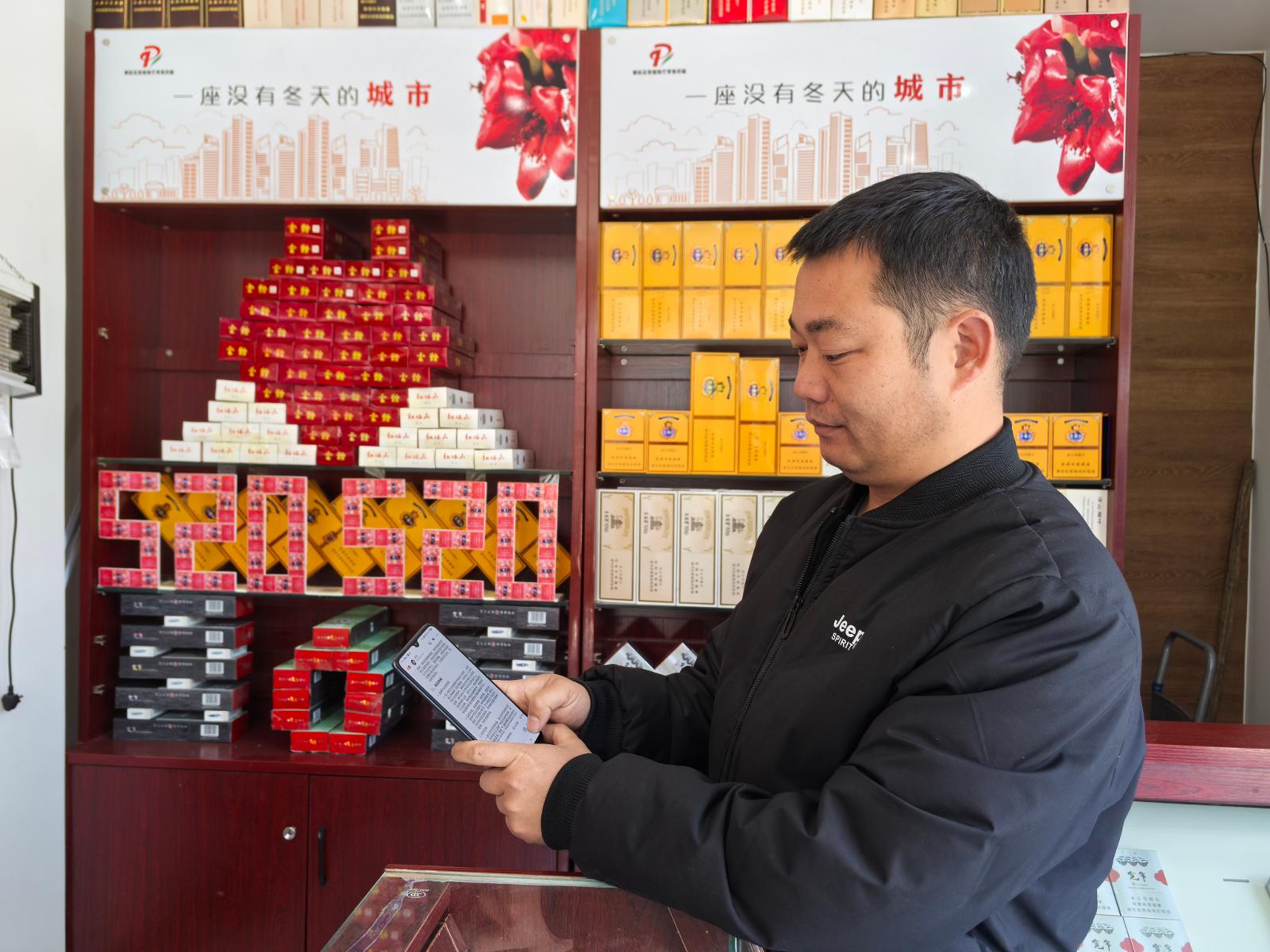 彭真鵬正在店內借助AI工具查詢資料.jpg