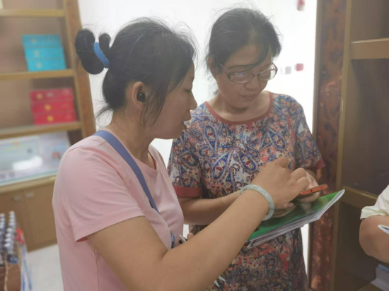 客戶經(jīng)理指導(dǎo)新辦證零售戶操作手機端商品訂購 胡浩攝.pn
